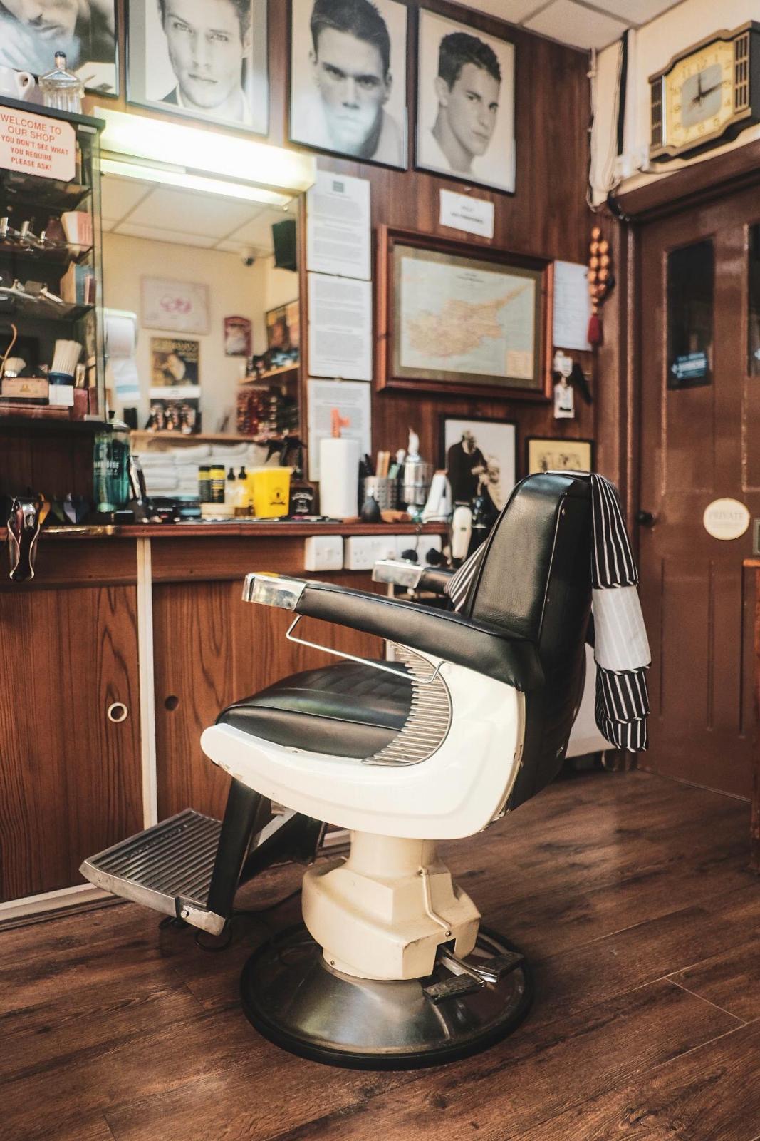 Vintage barber chair with mirror and portraits
